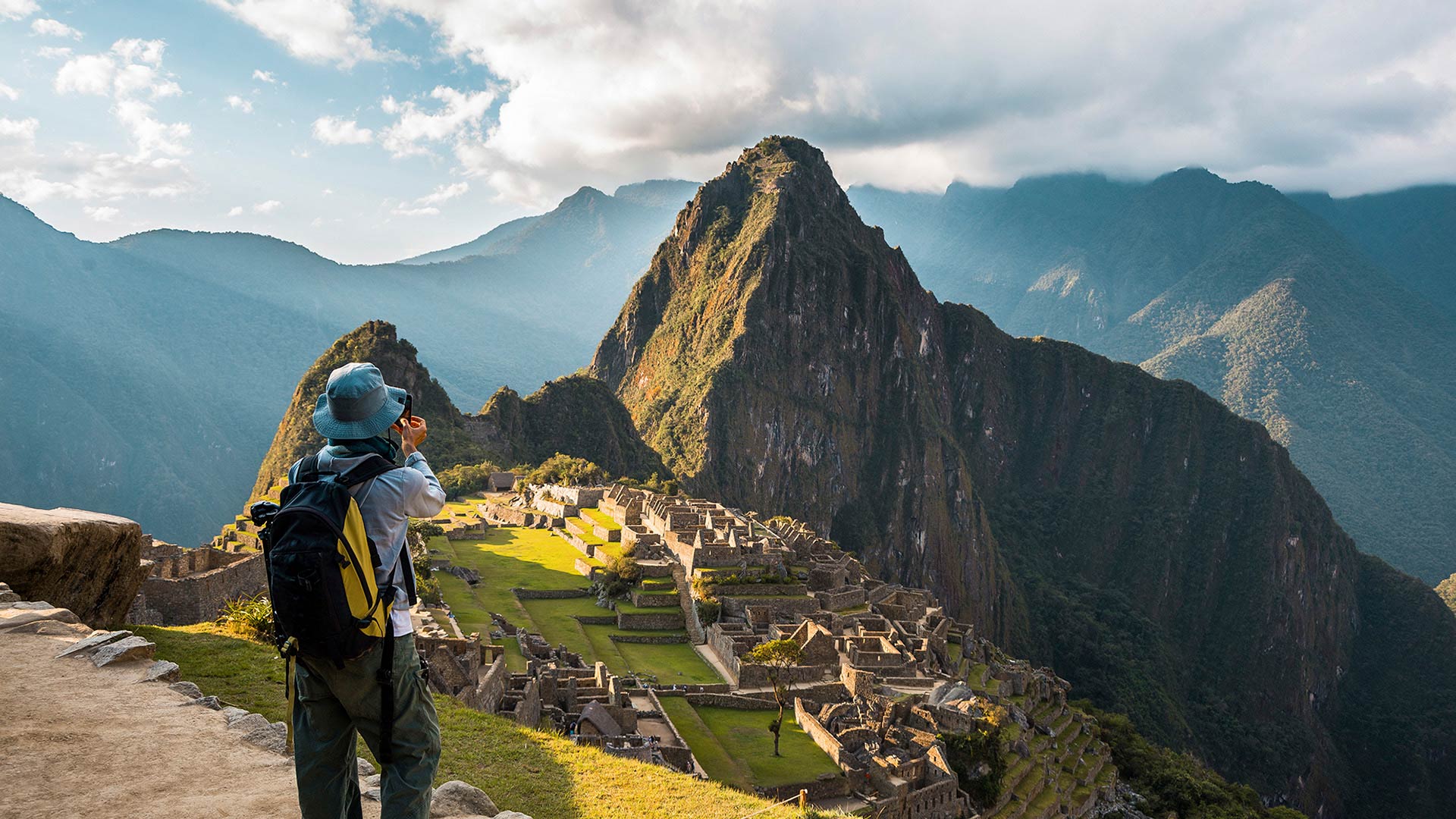 Tourist taking a photo to Machu Picchu wonder of the world