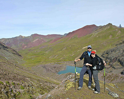 Couple enjoying the landscape with the background of a lagoon and mountains