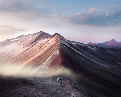 Man enjoying sunrise on Rainbow Mountain