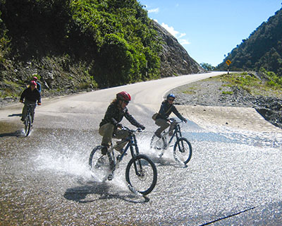 Men on bicycles crossing a river