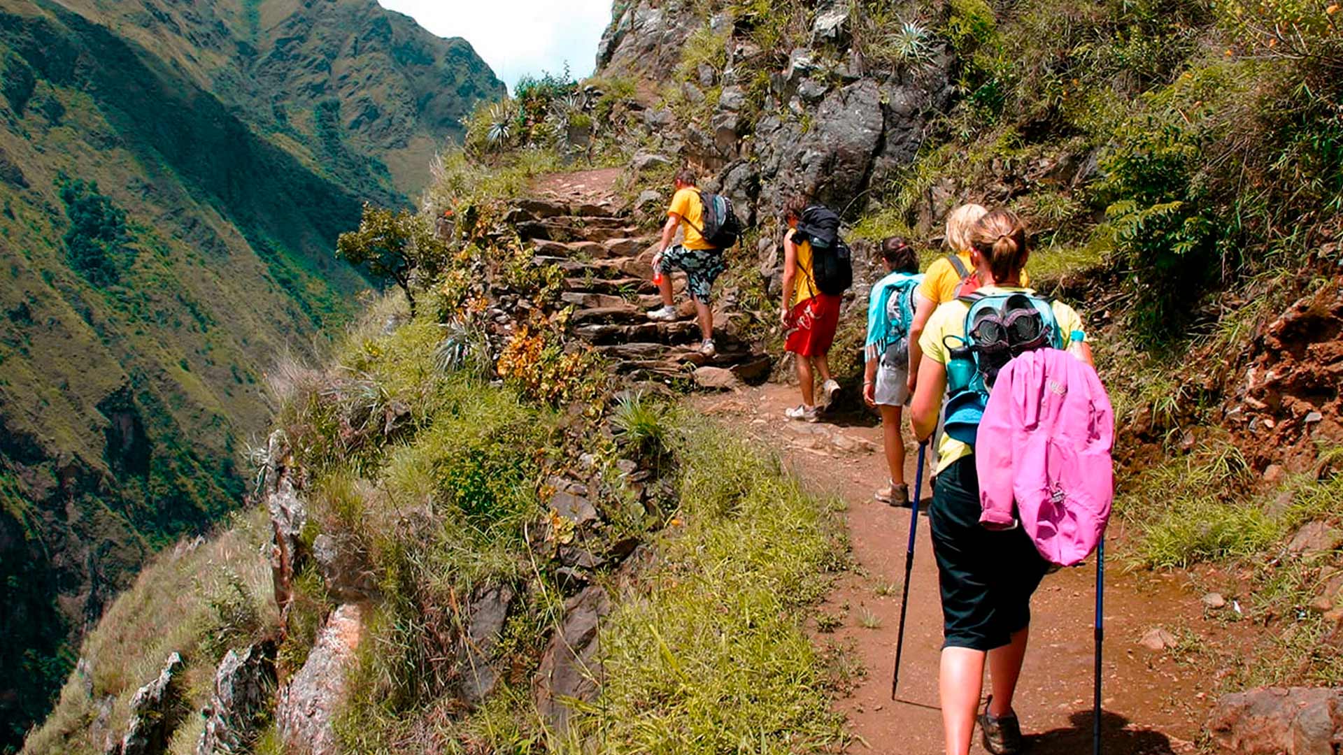 Passengers walking along the route of the Inca Jungle to Machu Picchu