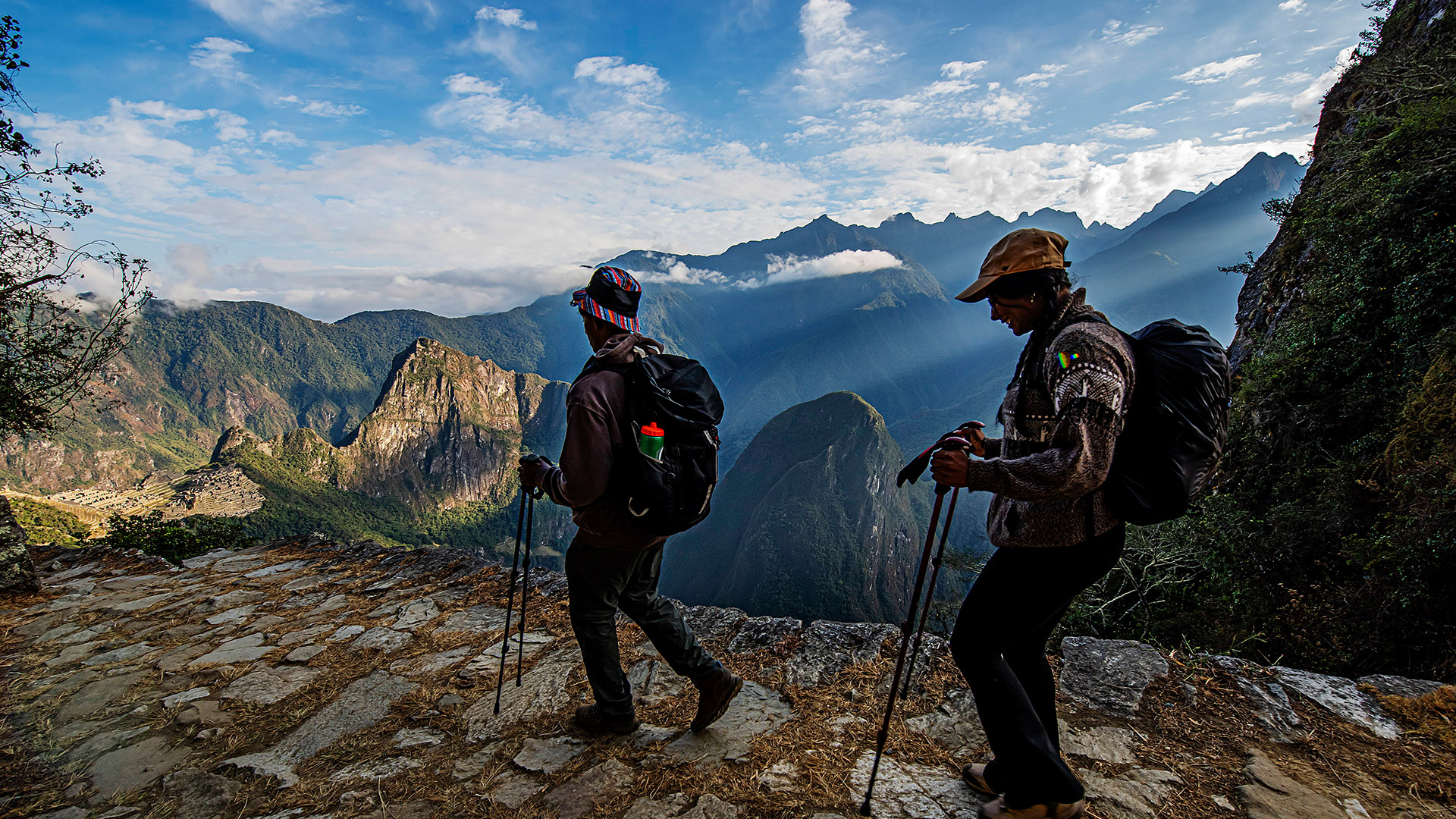 Panoramic view of tourists arriving at Machu Picchu by the classic Inca trail