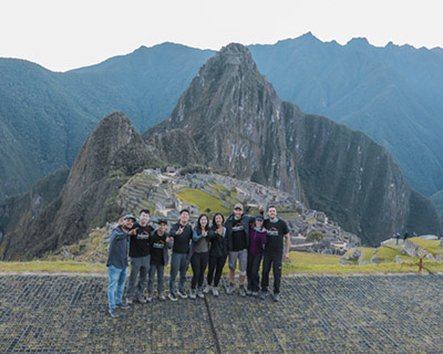 Group of trekkers and their guide at on the Machu Picchu viewpoint